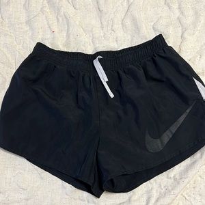 Women’s black Nike athletic shorts in a size medium.